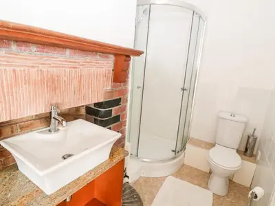 a bathroom with a sink and a shower at Penmarth House in Helston