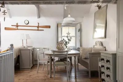 a kitchen with a table and chairs and a couch at Carvossa - Sea Views & Woodburner in Marazion