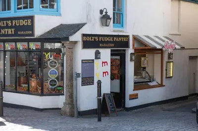 a group of shops on a street in a city at Carvossa - Sea Views & Woodburner in Marazion