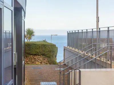a view of the ocean from the balcony of a house at Golden Sands in St Ives