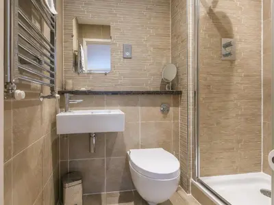 a bathroom with a toilet and a sink and a shower at Golden Sands in St Ives