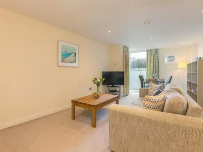 a living room with a couch and a tv at Golden Sands in St Ives
