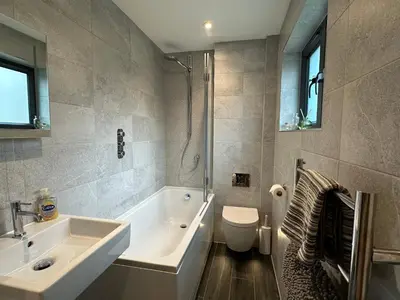 a bathroom with a sink and a tub and a toilet at Primrose in Bodmin