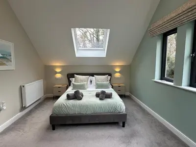 a bedroom with a bed with two teddy bears on it at Primrose in Bodmin