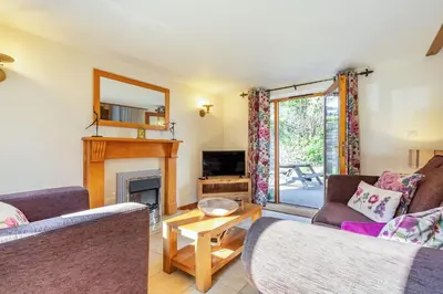 a living room with two couches and a fireplace at Miller's Lodge in Liskeard