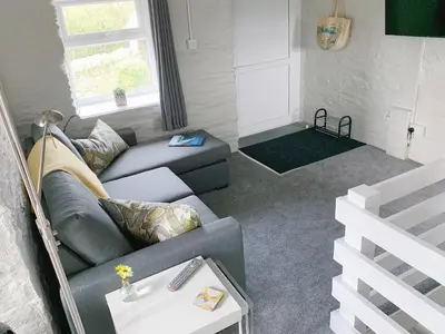 a living room with a couch and a table at The Laurels Holiday Park & Cottages nr Padstow and Wadebridge in Wadebridge