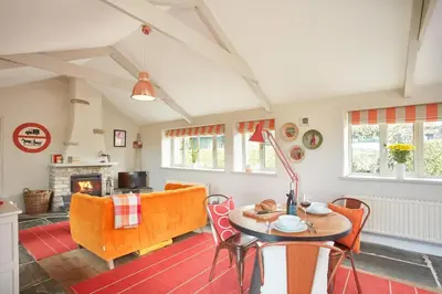 a living room with a table and a couch at Meadow View in Newquay