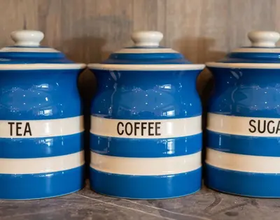 a group of four blue water bottles sitting on a table at Brookside in Polzeath