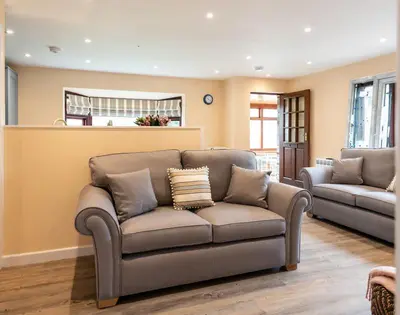 a living room with a couch and a chair at Brookside in Polzeath