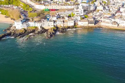 an aerial view of a village on the ocean at Men an Mor in St Ives