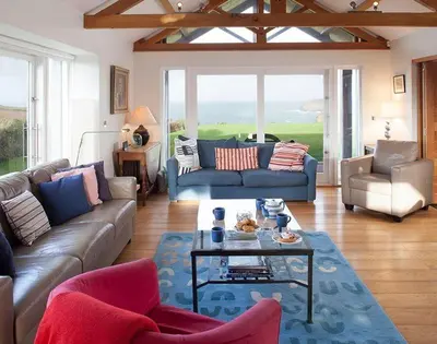 a living room with a couch and a table at Ossco in Polzeath