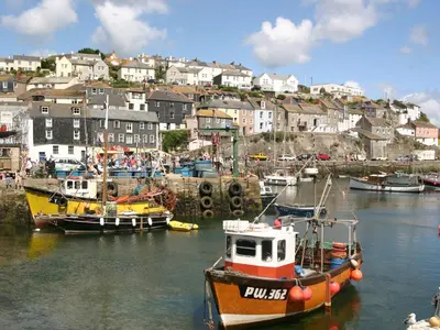 a group of boats are docked in a harbor at Tremethic in St Austell