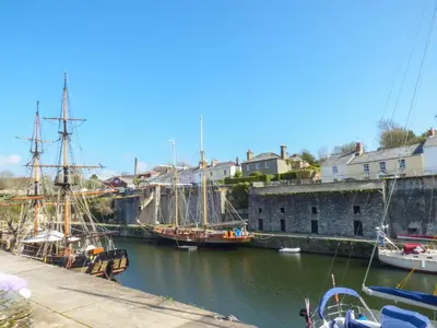 a group of boats are docked in a harbor at Tremethic in St Austell