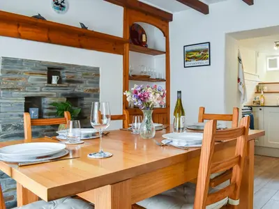 a dining room with a wooden table and chairs at Trevivian House in Boscastle