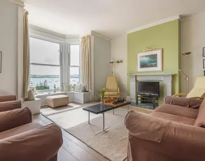 a living room with a couch and a fireplace at 4 The Terrace in Padstow