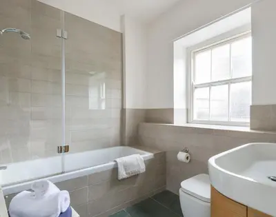 a bathroom with a tub and a toilet and a sink at 4 The Terrace in Padstow