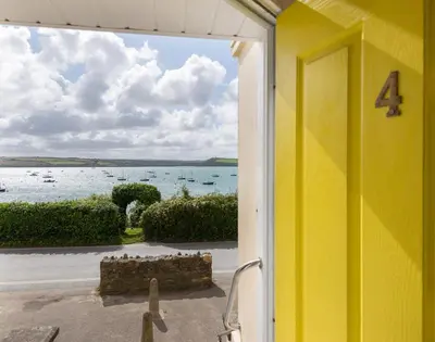 a yellow house with a view of the ocean at 4 The Terrace in Padstow