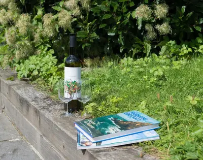 a bottle of wine sitting next to some books at 4 The Terrace in Padstow