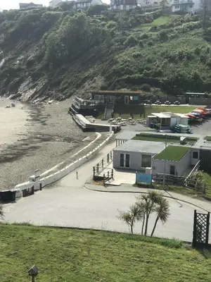 a view of a beach with some buildings and the ocean at Ocean View Apartments in Looe