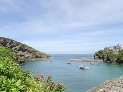 a group of boats in a body of water at Kelmscot in Port Isaac