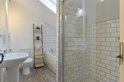a bathroom with a shower and a sink and a toilet at Kelmscot in Port Isaac