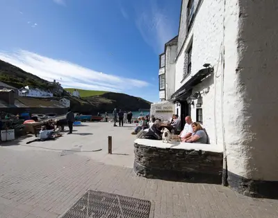 a group of people sitting outside of a building at Cloam Cottage in Port Isaac