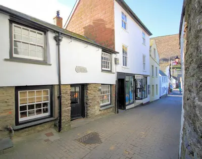 an empty street in a town with buildings at Cloam Cottage in Port Isaac