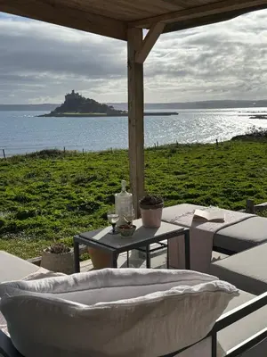 a table and chairs with a view of the ocean at The Tidal Shore - Adults Only - in Marazion