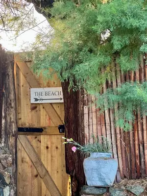 a wooden fence with a gate with a sign on it at The Tidal Shore - Adults Only - in Marazion