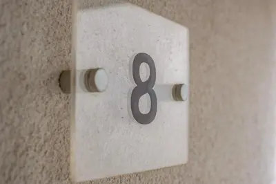 a white lightswitch with the number eight on it at Beach Haven in Perranporth