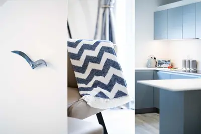 two pictures of a kitchen with a towel on a chair at Tides in Carbis Bay