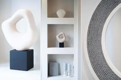 a white vase on a shelf next to a mirror at Tides in Carbis Bay