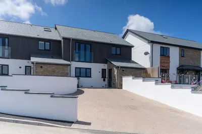 a row of houses with a driveway at Tides in Carbis Bay