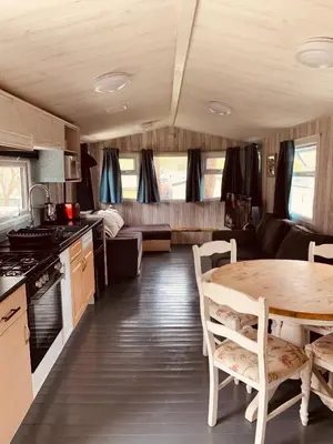 a kitchen and dining room with a table in a caravan at 94 Newquay Bay Resort pet friendly in Newquay