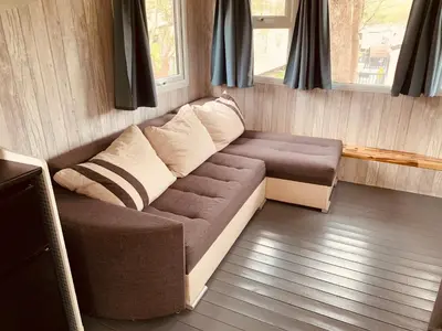 a living room with a couch and a window at 94 Newquay Bay Resort pet friendly in Newquay