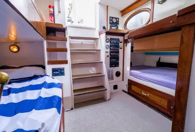 a small bedroom with a bunk bed and a bunk bed at Stunning Yacht Sea Lion in Charlestown Harbour, Cornwall in Charlestown
