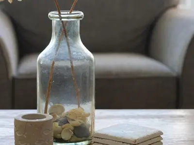 a glass vase with rocks in it on a table at The Porthole in Port Isaac