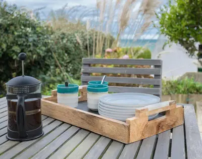 a tray of plates and bowls on a wooden table at Albany in Port Isaac