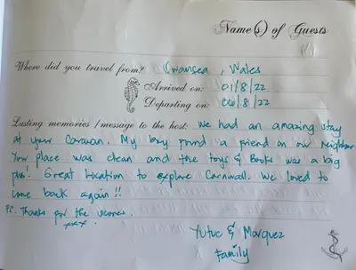 a letter with blue handwriting on a white paper at Newquay Bay Resort - Sea Breeze 61 in Newquay