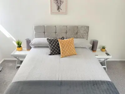 a bedroom with a large bed with pillows on it at Cosy retreat in beautiful Cornwall in Helston
