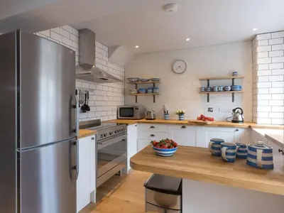 a kitchen with a stainless steel refrigerator and a counter at Marchbourne in St Ives