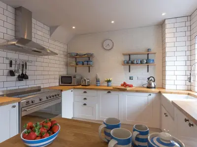 a kitchen with a bowl of fruit on the floor at Marchbourne in St Ives