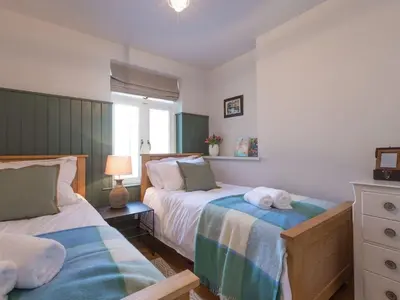 a bedroom with two beds with towels on them at Marchbourne in St Ives