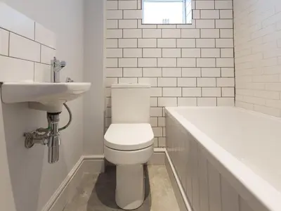 a bathroom with a toilet and a sink and a tub at Marchbourne in St Ives