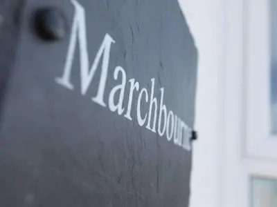 a sign on a wall with the name of a pharmacy at Marchbourne in St Ives