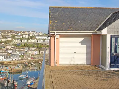 a house with a garage on the side of it at Wheal Kendall in St Austell