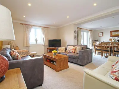 a living room with two couches and a table at Wheal Kendall in St Austell