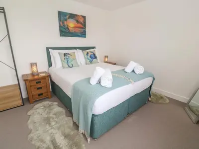 a bedroom with a bed with two pillows on it at 3 Praa Cove in Penzance