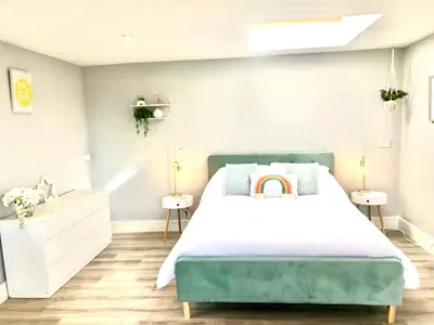 a bedroom with a bed and two night stands at Detached, peaceful, spacious with easy access and very large garden in Wadebridge