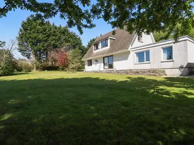 a house with a large lawn in front of it at Chyrosen in Redruth